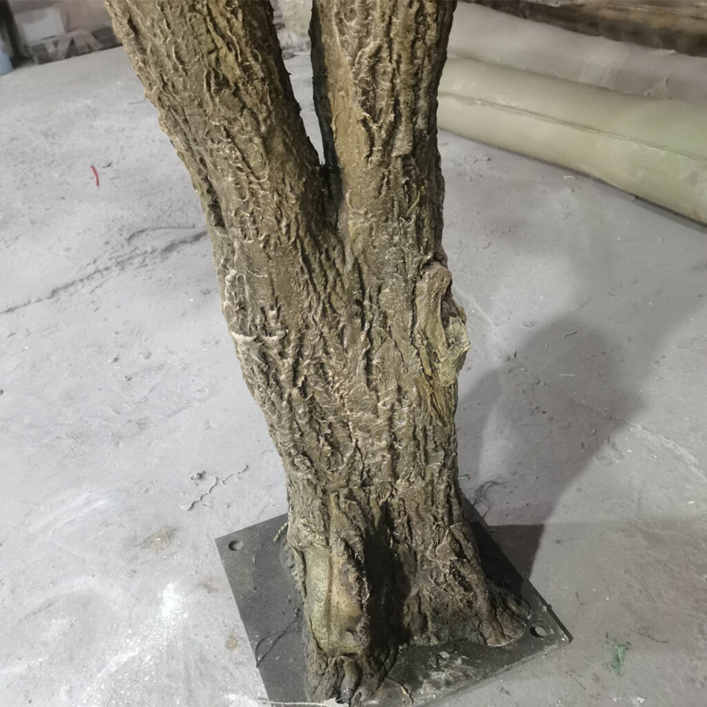 Outdoor artificial olive tree installed by a poolside
