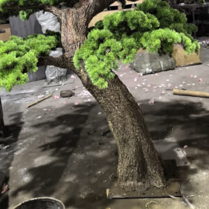Hand-sculpted trunk detail of a custom artificial pine tree